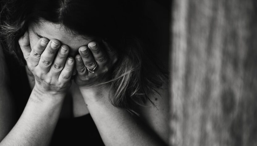 grayscale photography of crying woman