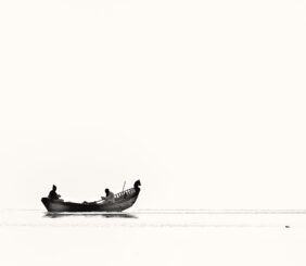 two person riding boat on body of water