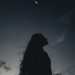 lonely woman under night sky