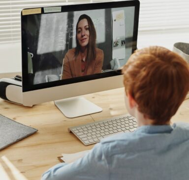 photo of boy video calling with a woman