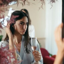 a pretty woman holding a champagne glass with rose wine