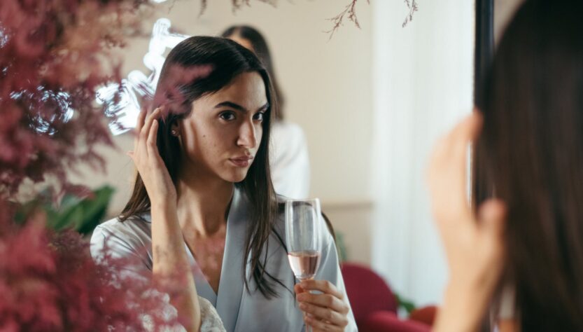 a pretty woman holding a champagne glass with rose wine