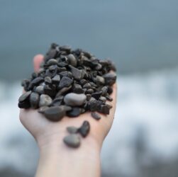photo of person holding stones