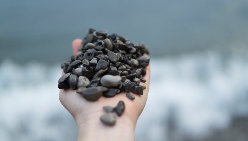 photo of person holding stones